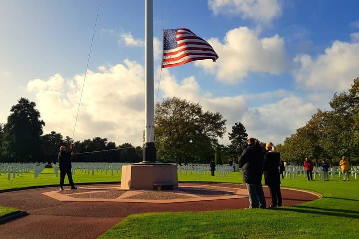 Taking down the flag at the American Cemetery