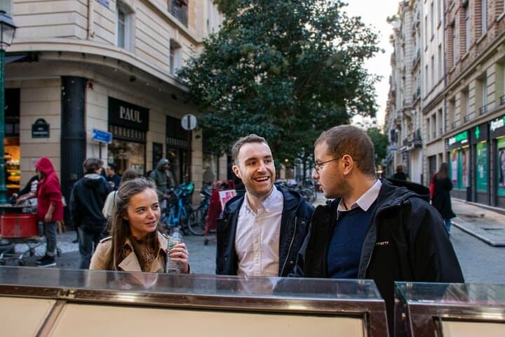 3 people on a street talking