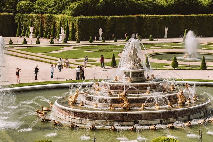 Explore the royal gardens with fountains, sculptures, and sweeping views