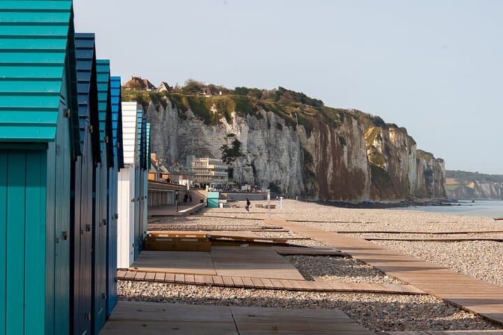 Beach and Cliffs: The colorful beach cabins at the foot of the spectacular Alabaster Coast.