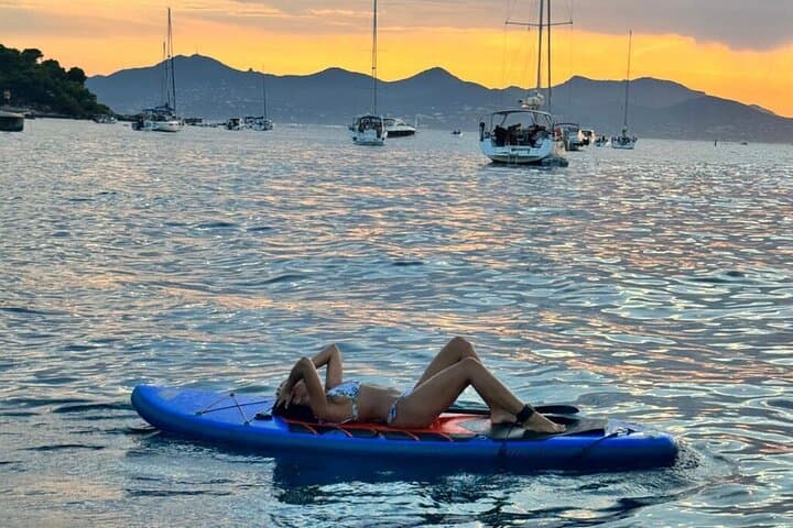 Relax on the paddleboard at sunset, included in your private all-inclusive tour.