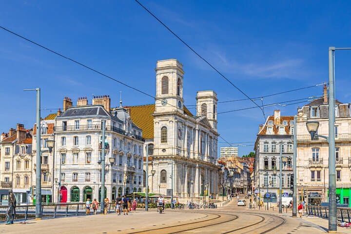 September 8 Square: The beating heart of the city where the modern tram crosses the facade of St. Peter's Church.