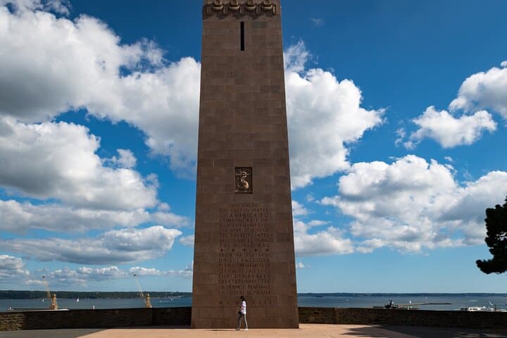 American Monument (Cours Dajot): The pink granite memorial tower overlooking the harbor, symbol of the shared history of the city.