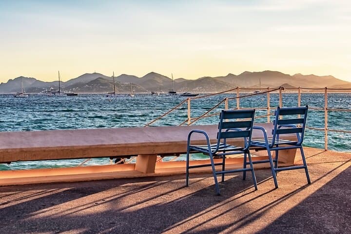 La Croisette: The famous blue chairs facing the Bay of Cannes and the Esterel massif.