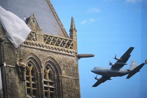 Sainte Mère l'Eglise - Airborne Museum - A dummy paratrooper is still hung on top of the church 'steeple