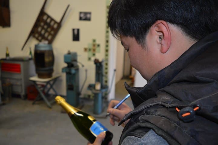 Winemaker signing a bottle
