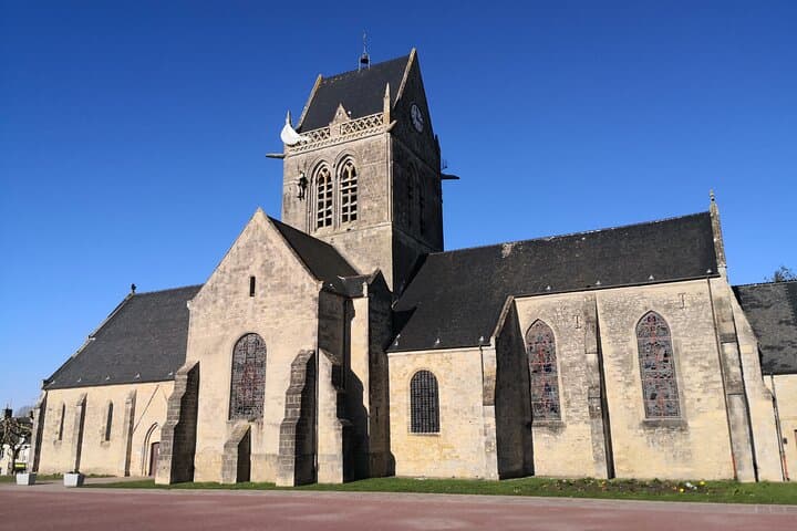 Sainte Mère l'Eglise - A dummy paratrooper is still hung on top of the church 'steeple
