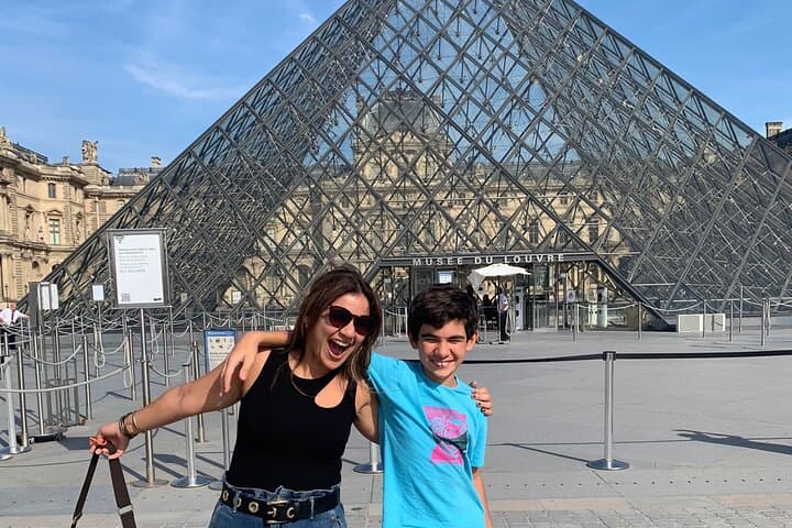 Happy Clients in front of the Louvre Museum's Pyramid.