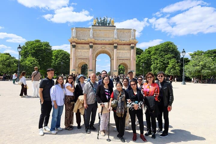 We'll pause at the grand Arc de Triomphe du Carrousel, right in front of the Louvre, for a beautiful view of the museum's courtyard and the glass pyramid.