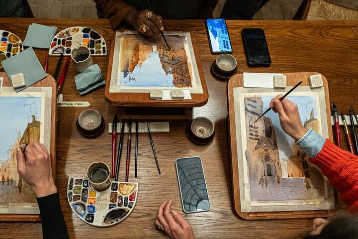 Guests paint side-by-side using premium watercolor materials — a calm, focused moment at the heart of the workshop.