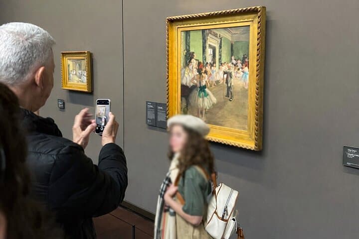 Kid posing in front of Degas's artwork