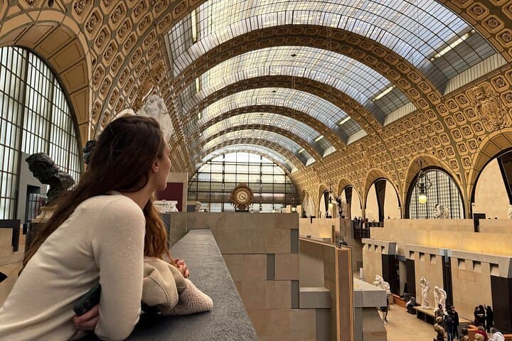 Tourist admiring the inside of Orsay's old train station