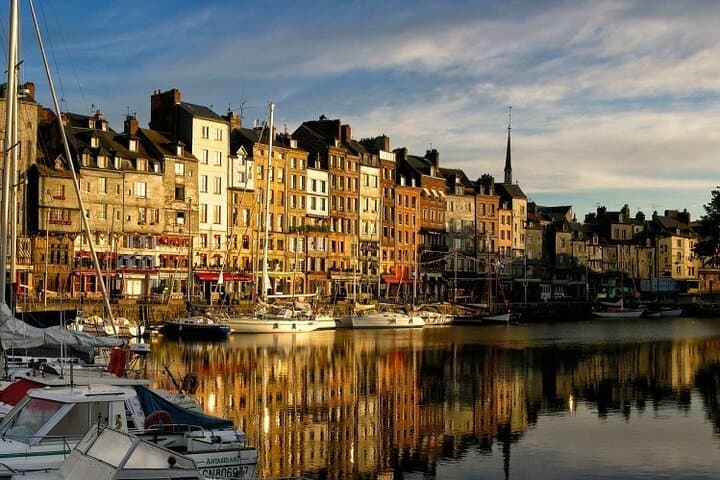 Stroll through Honfleur’s charming harbor — a highlight of your Normandy excursion.