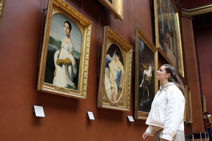 Tourist admiring paintings