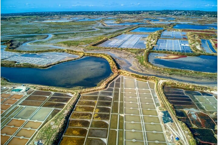 Salt marshes: Aerial view of the spectacular mosaic of the evaporation basins where the famous Fleur de sel is harvested.