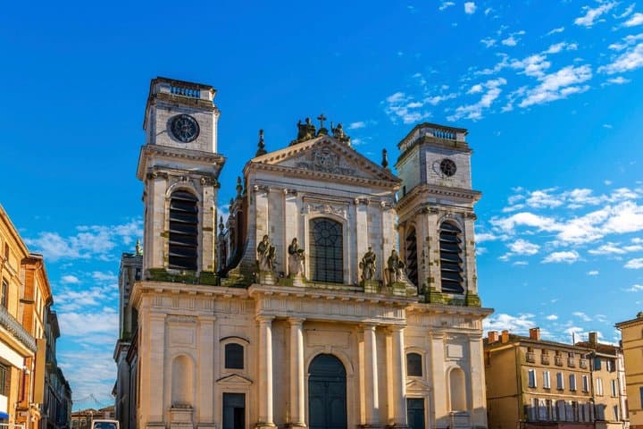Cathedral of Our Lady of the Assumption: The surprising white stone facade that contrasts with the red brick of the city, wanted by Louis XIV.
