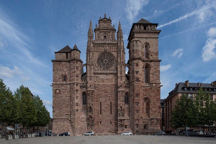 Notre-Dame Cathedral: The imposing pink sandstone fortress and its serrated bell tower, an absolute masterpiece of the flamboyant Gothic.